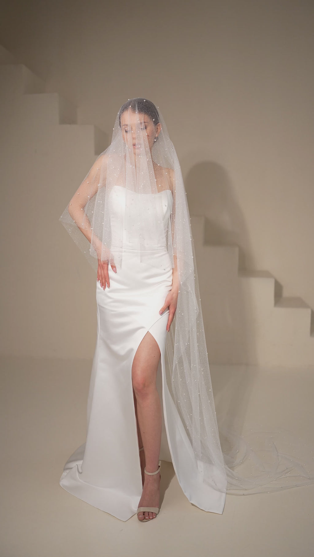 Bride wearing pearl sparkly ivory wedding veil